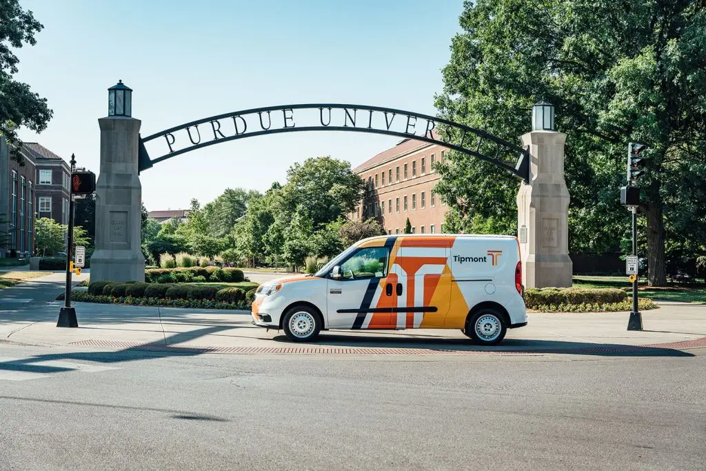 A Tipmont van parked in front of a Purdue University sign